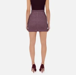 Elisabetta Franchi Tailleur|Skirts|Crêpe miniskirt with diamond print and chain RougeNoir/Butter